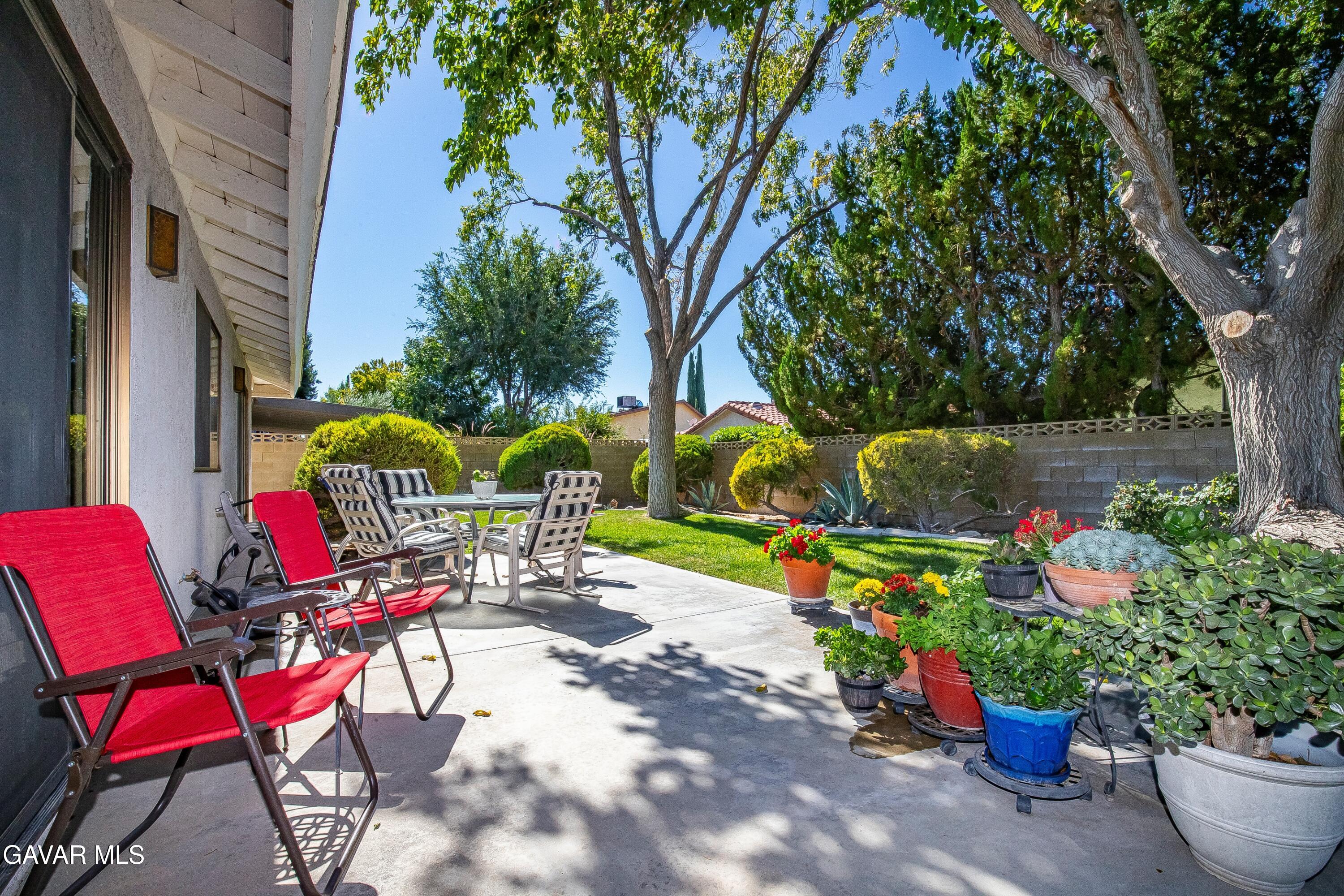 43755 Sentry Lane Lancaster, CA 93536 - Photo 29 of 36 a view of a chairs and tables in a backyard
