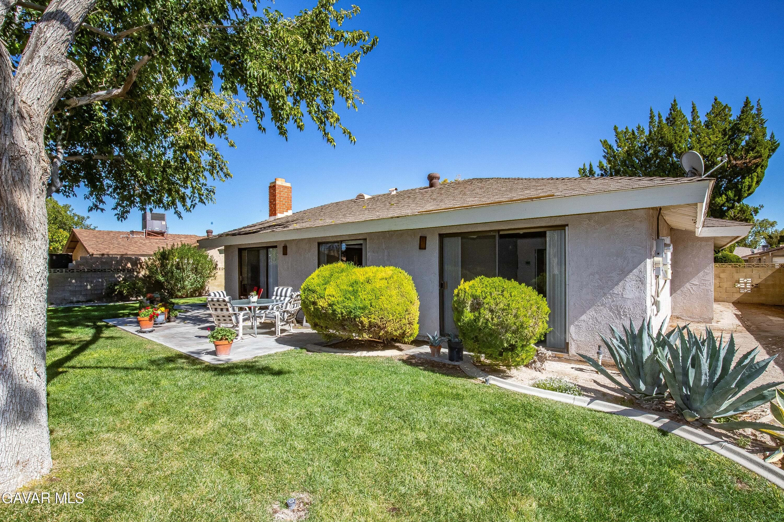 43755 Sentry Lane Lancaster, CA 93536 - Photo 31 of 36 a view of a house with backyard sitting area and garden