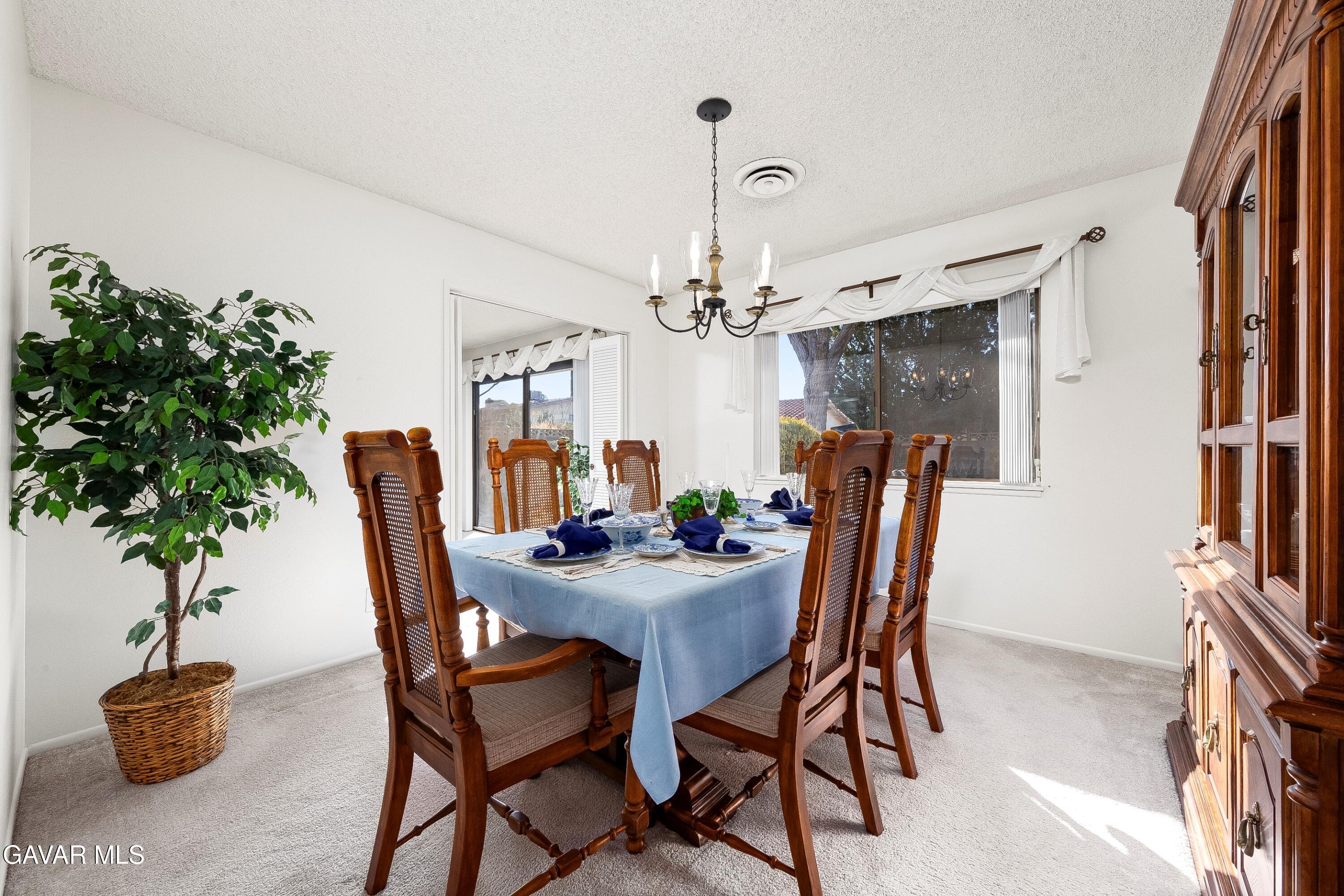 43755 Sentry Lane Lancaster, CA 93536 - Photo 6 of 36 a dining room with furniture and potted plant