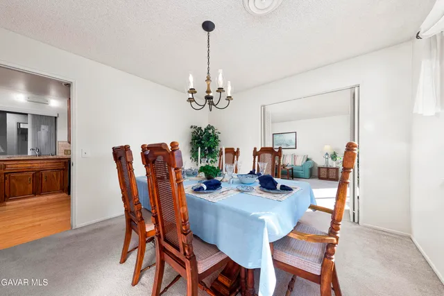 a dining room with furniture and chandelier