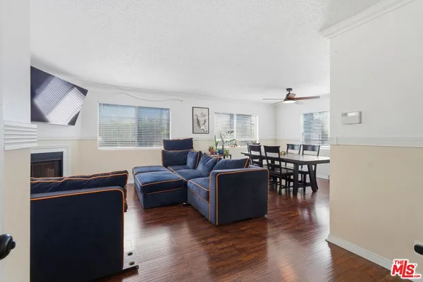 a living room with furniture a fireplace and a window