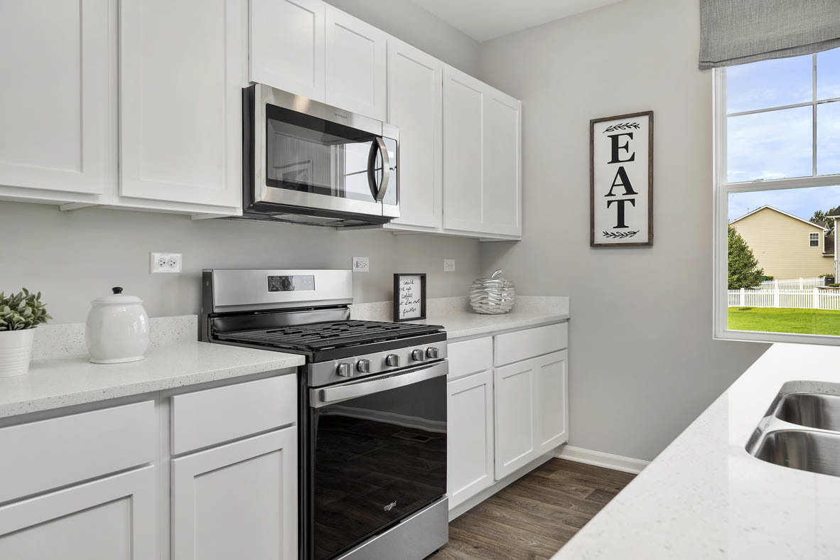 1806 Overland Drive Plainfield, IL 60586 - Photo 3 of 21 a kitchen with cabinets a stove and a wooden floor