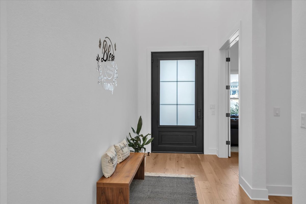 2312 Mondello Path Leander, TX 78641 - Photo 9 of 40 Doorway with wood finished floors and baseboards