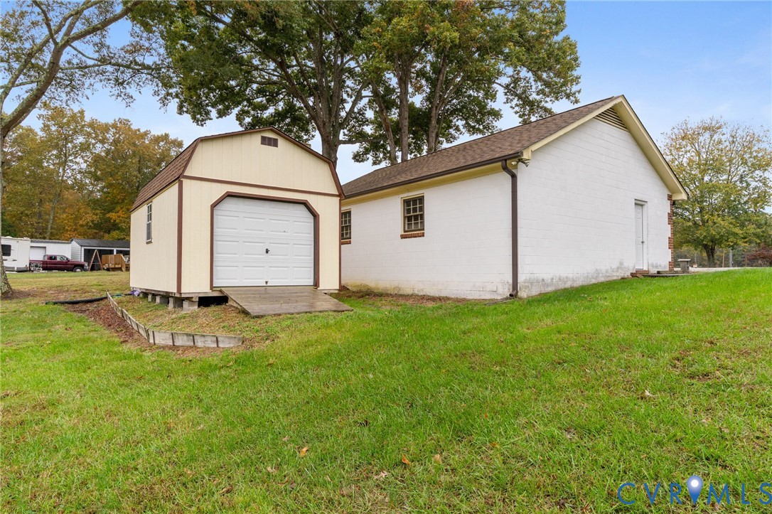 6163 White Oak Road Sandston, VA 23150 - Photo 30 of 39 a view of a white house with a yard and large tree