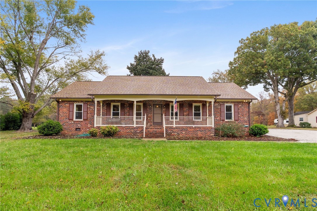 6163 White Oak Road Sandston, VA 23150 - Photo 3 of 39 a front view of a house with a yard and trees