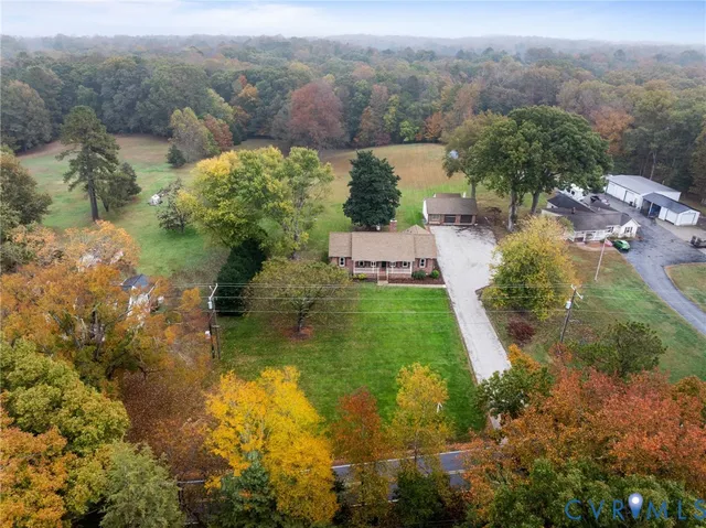a view of a backyard with lawn chairs