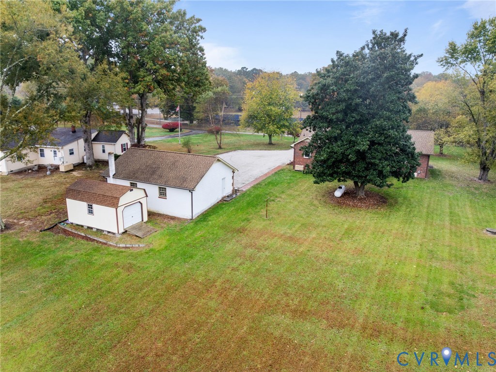 6163 White Oak Road Sandston, VA 23150 - Photo 37 of 39 a view of a patio with table and chairs potted plants and large tree