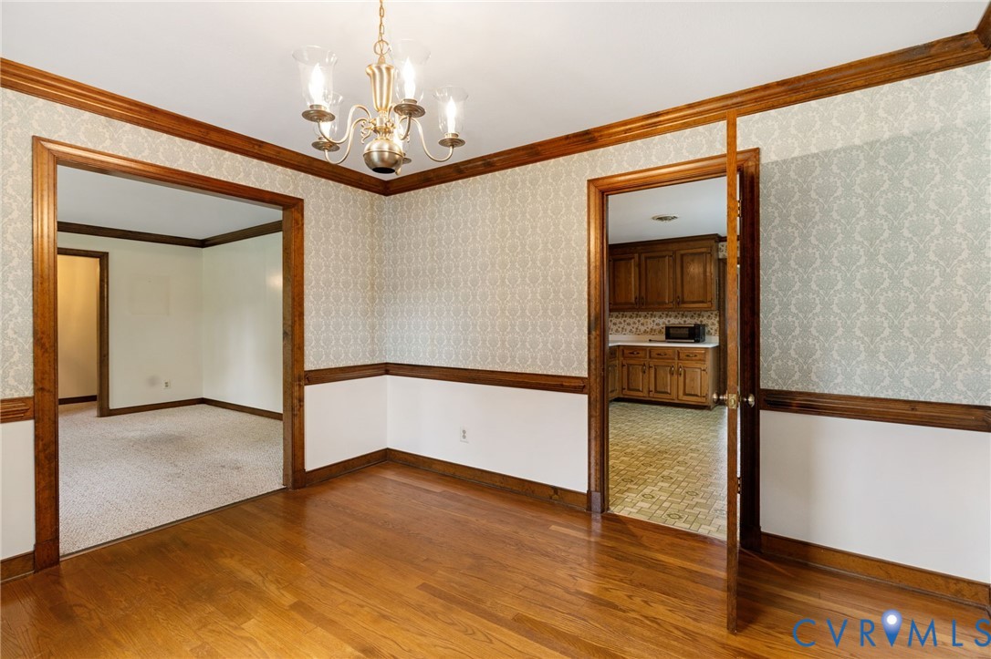 6163 White Oak Road Sandston, VA 23150 - Photo 9 of 39 a view of a hallway with wooden floor and staircase