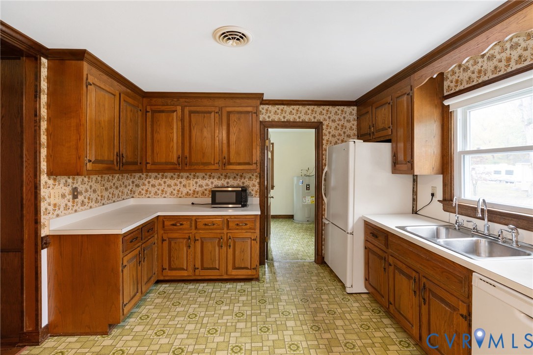 6163 White Oak Road Sandston, VA 23150 - Photo 10 of 39 a kitchen with stainless steel appliances granite countertop a sink stove and refrigerator