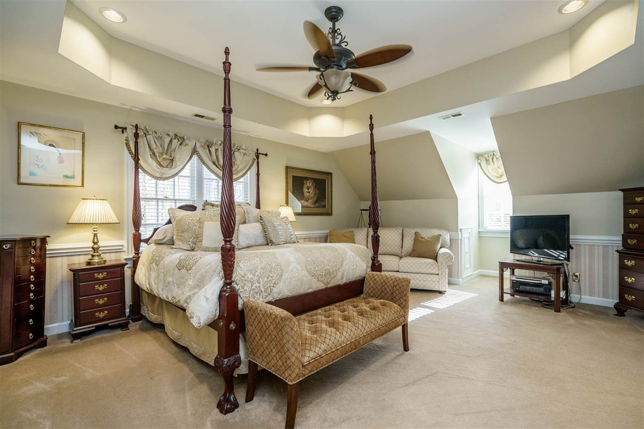 1028 Mersey Lane Raleigh, NC 27615 - Photo 15 of 30 Owners Suite with tray ceiling, direct lighting, ceiling fan and carpet floors. Owner's Suite
