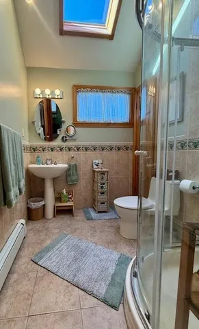 a bathroom with a sink a toilet and a shower