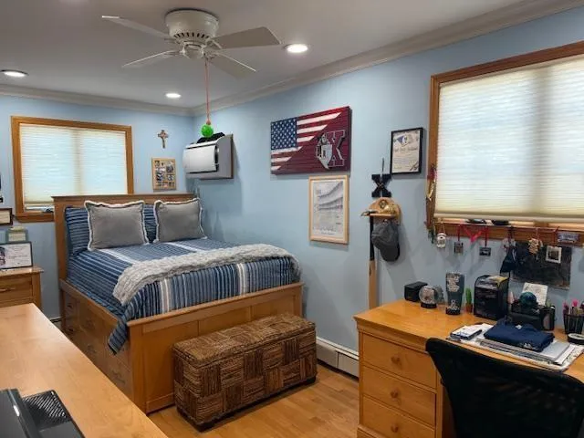 a bedroom with furniture and a flat screen tv