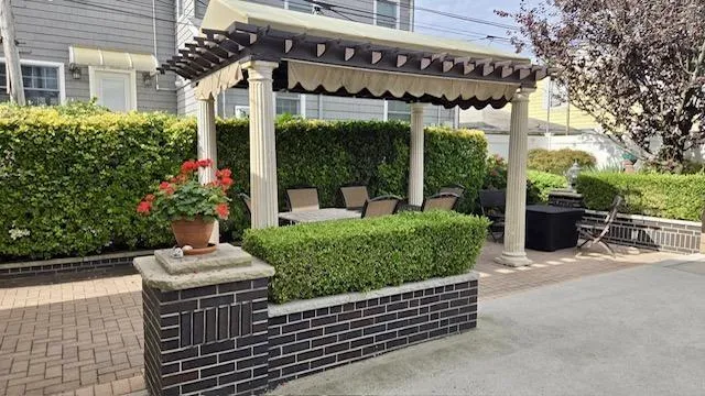 front view of a house with a bench