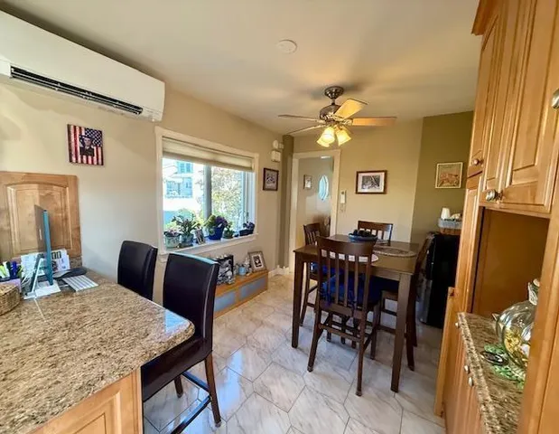 a view of a dining room with furniture and a chandelier