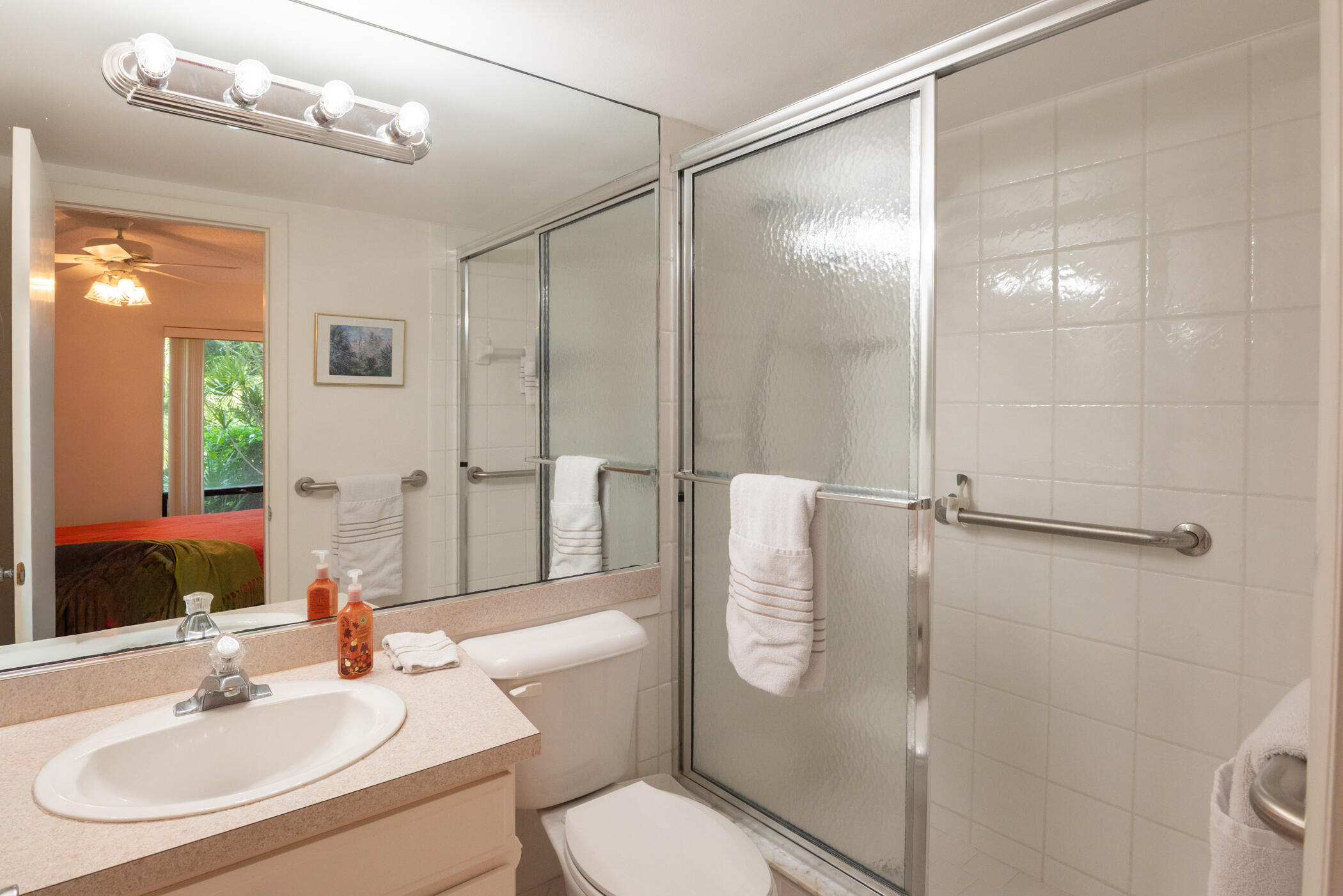 2550 Presidential Way, Unit 107 West Palm Beach, FL 33401 - Photo 16 of 28 a bathroom with a sink a toilet and shower
