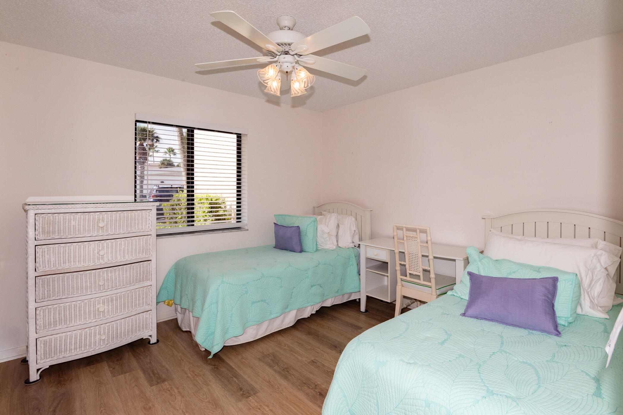 2550 Presidential Way, Unit 107 West Palm Beach, FL 33401 - Photo 17 of 28 a bedroom with two beds and two night stand