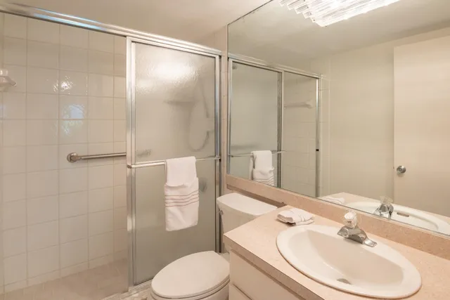 a bathroom with a sink toilet and shower