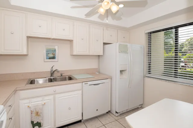 a kitchen with stainless steel appliances white cabinets and a sink