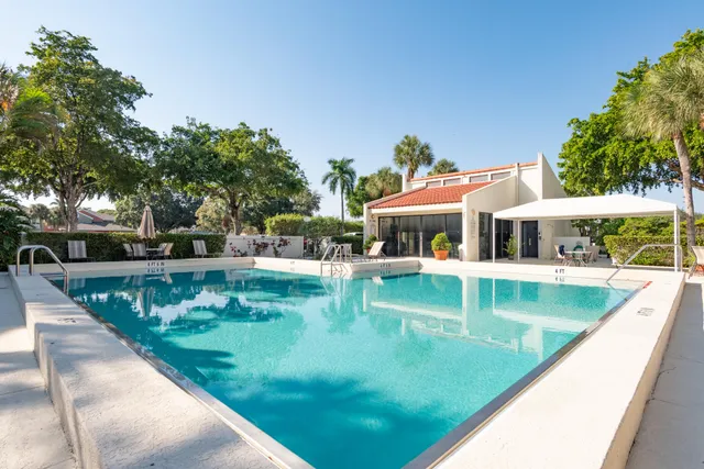 swimming pool view with a seating space