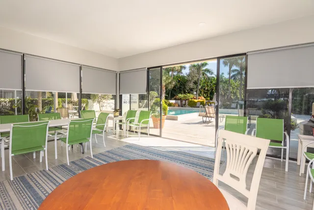 a view of a dining room with furniture wooden floor and garden view