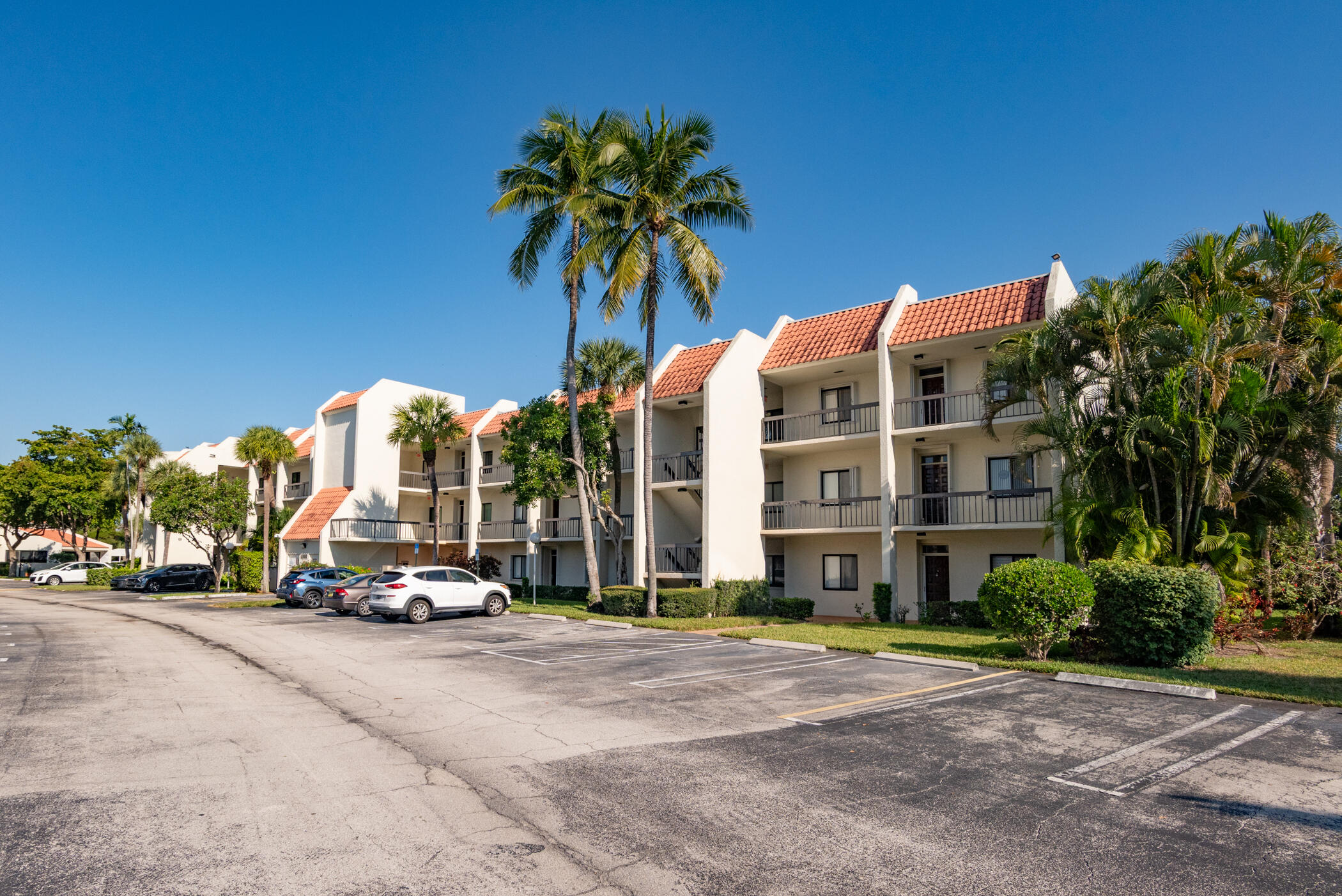 2550 Presidential Way, Unit 107 West Palm Beach, FL 33401 - Photo 27 of 28 a car parked on the side of a street