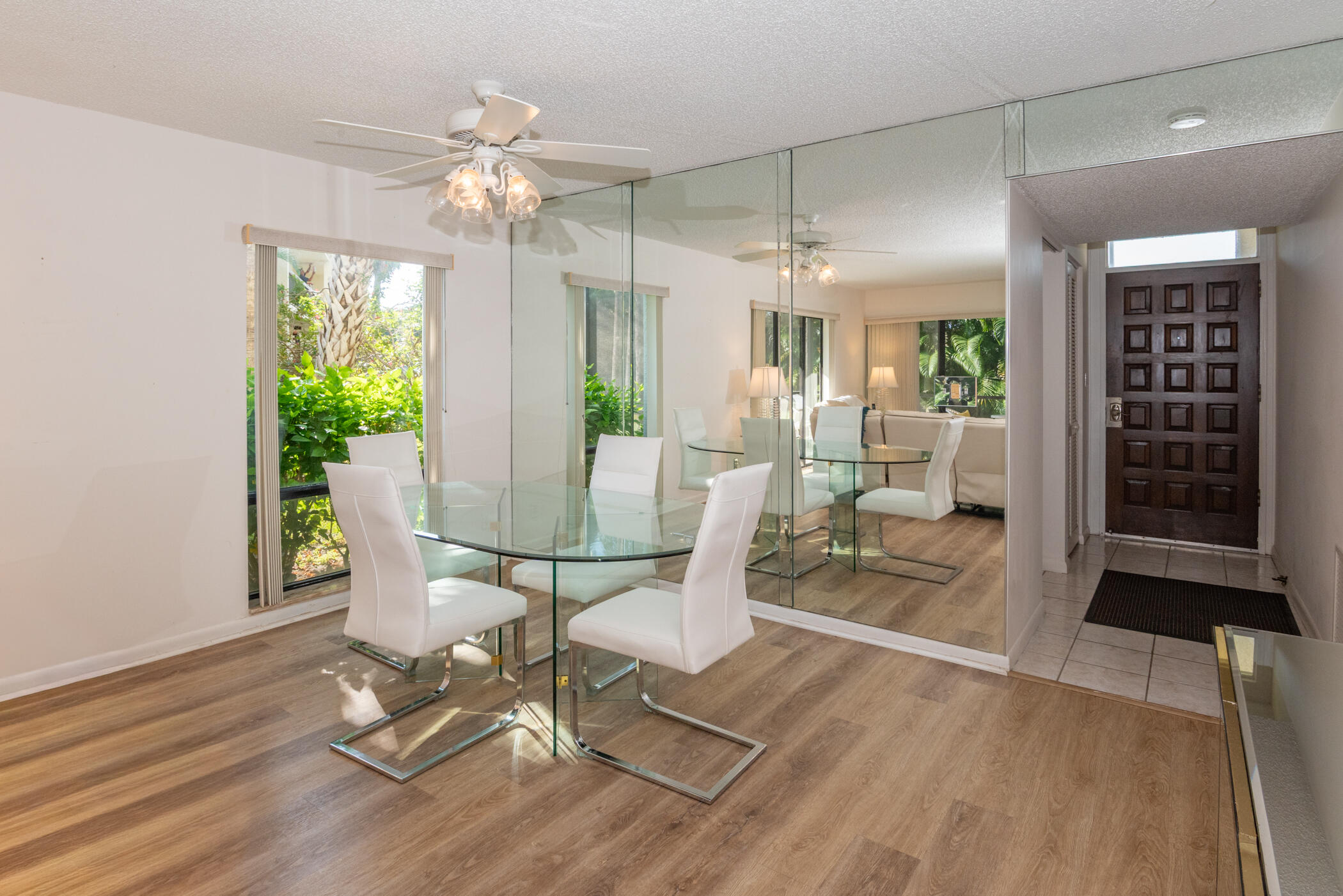 2550 Presidential Way, Unit 107 West Palm Beach, FL 33401 - Photo 6 of 28 a view of a dining room with furniture window and wooden floor