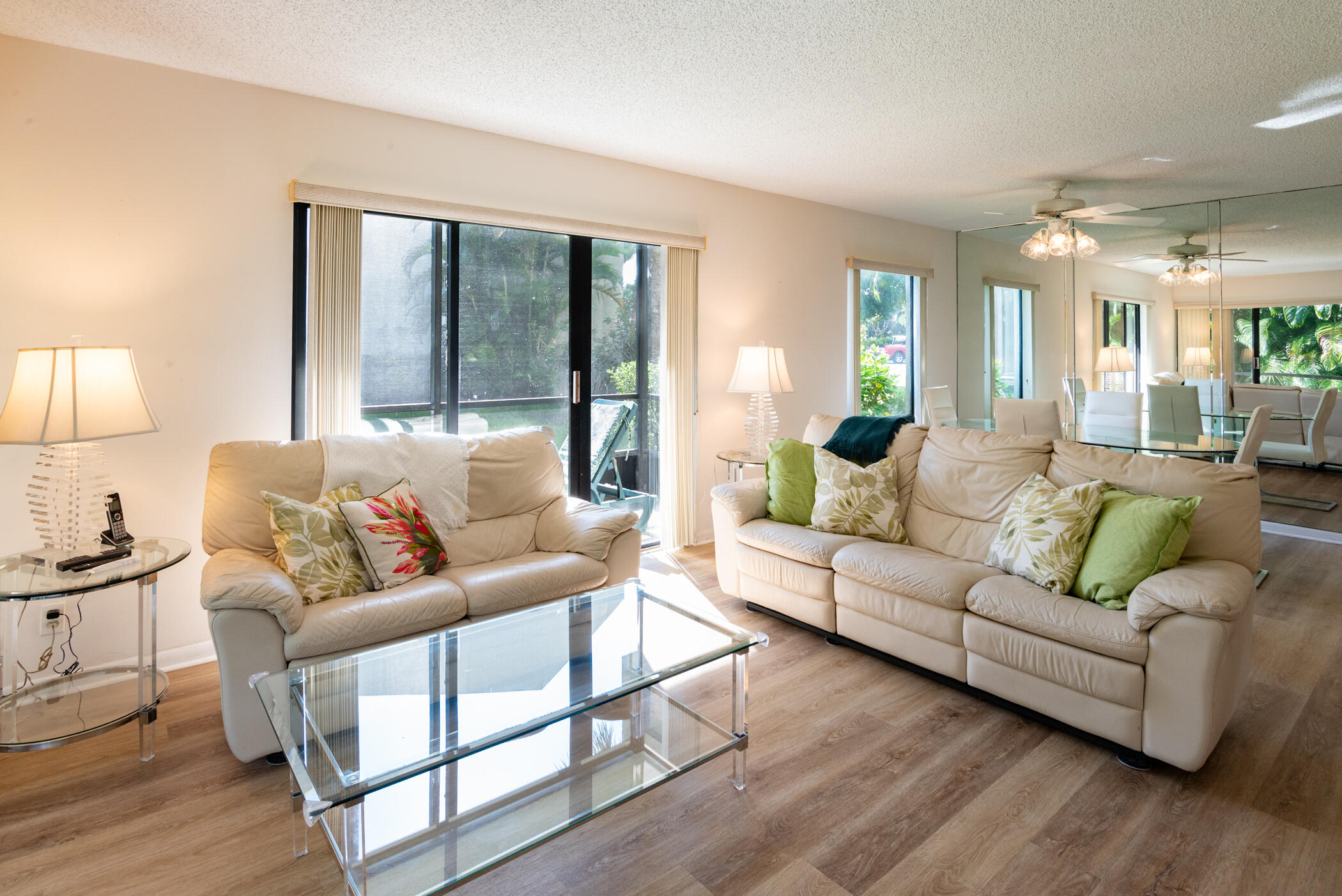 2550 Presidential Way, Unit 107 West Palm Beach, FL 33401 - Photo 7 of 28 a living room with furniture and a large window