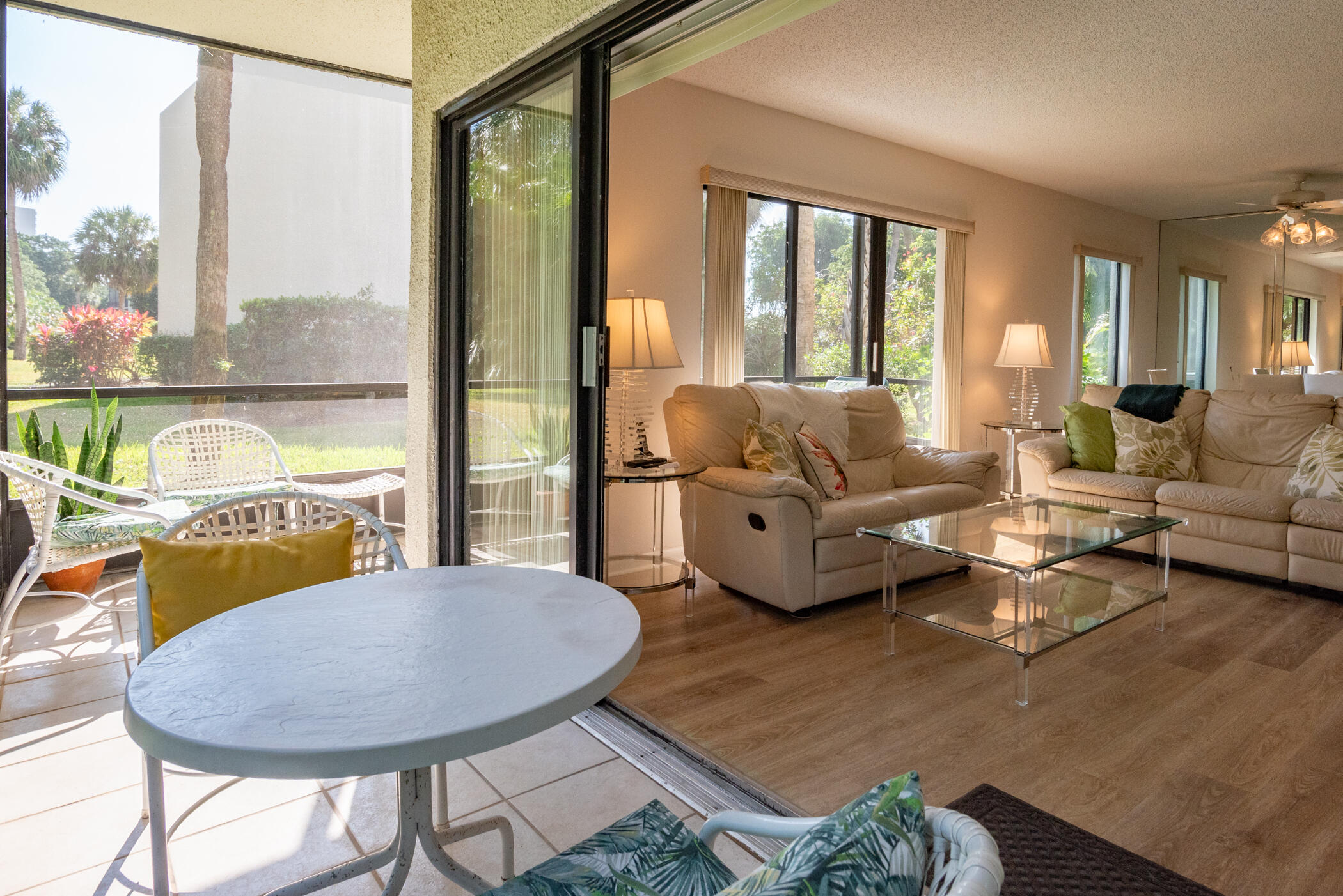 2550 Presidential Way, Unit 107 West Palm Beach, FL 33401 - Photo 10 of 28 a living room with furniture and a large window