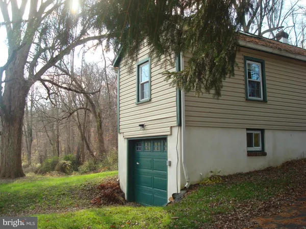 a view of backyard of house and trees