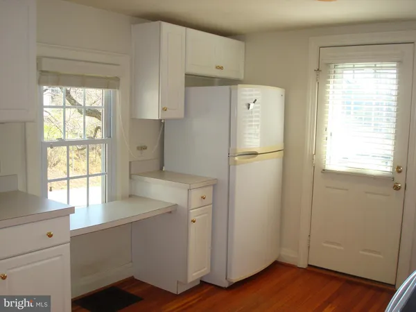 a white refrigerator freezer sitting inside of a kitchen