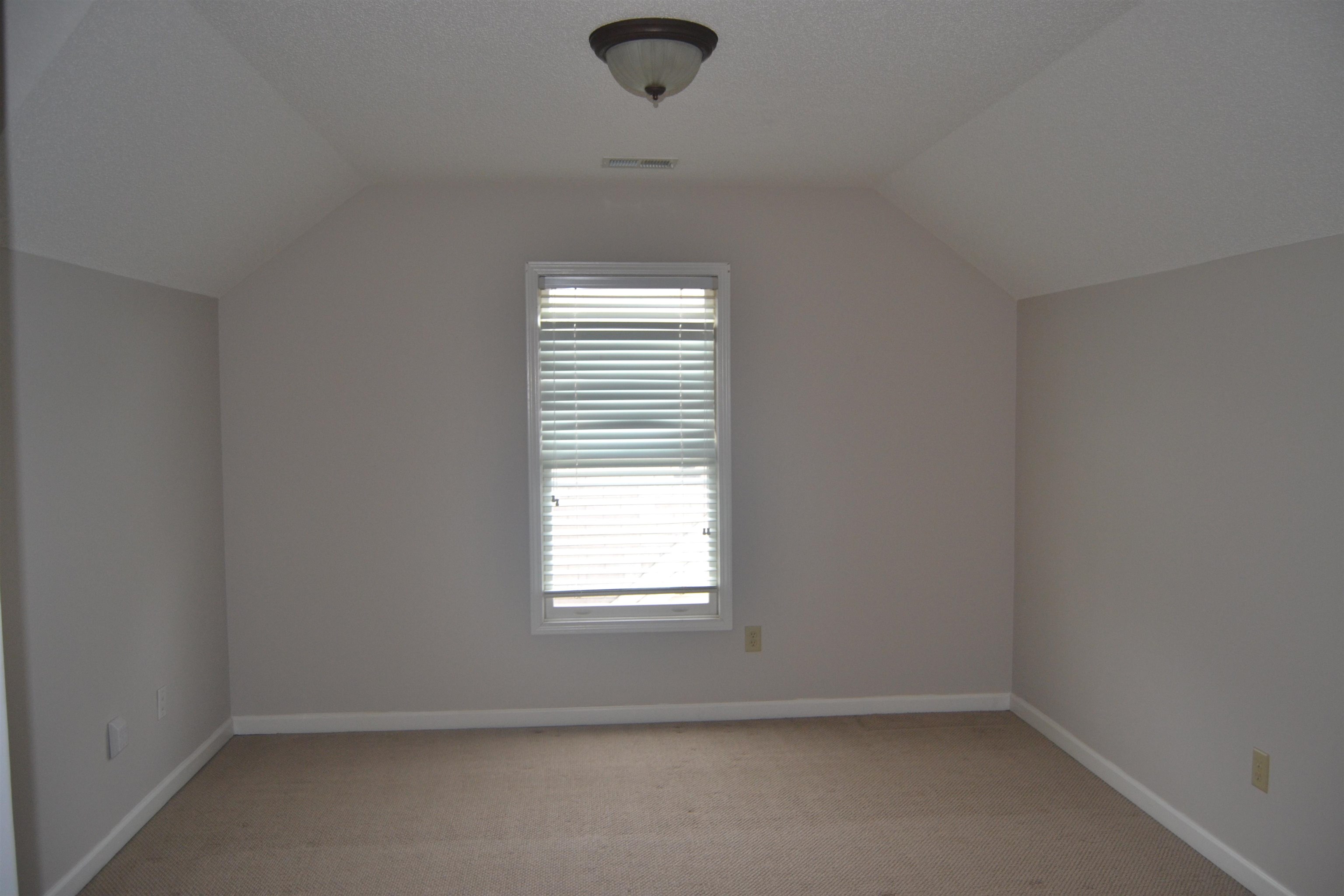 10486 Juneau Way Collierville, TN 38017 - Photo 32 of 33 Bonus room with light colored carpet and lofted ceiling