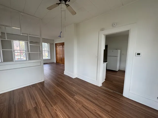 a view of a room with wooden floor and a window