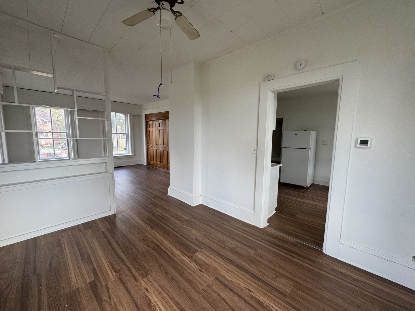 402 Joliet Street, Unit 1 West Chicago, IL 60185 - Photo 7 of 12 a view of a room with wooden floor and a window