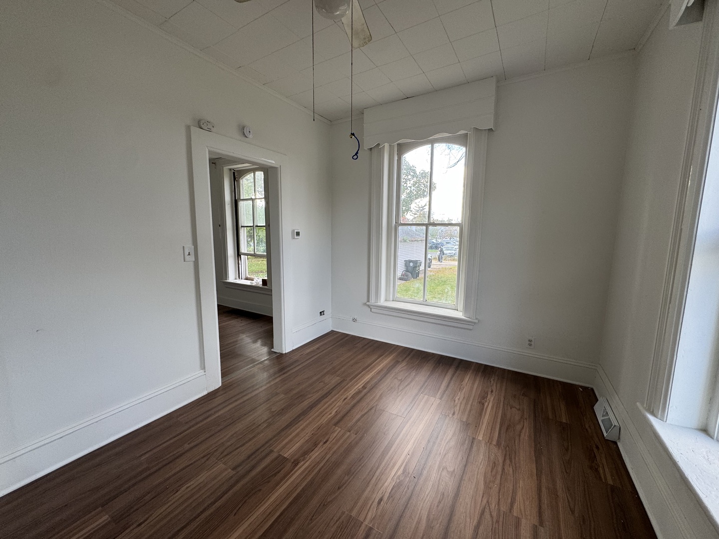 402 Joliet Street, Unit 1 West Chicago, IL 60185 - Photo 8 of 12 an empty room with wooden floor and windows