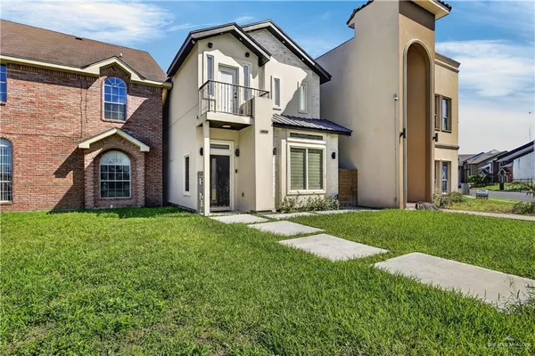 a front view of a house with a yard