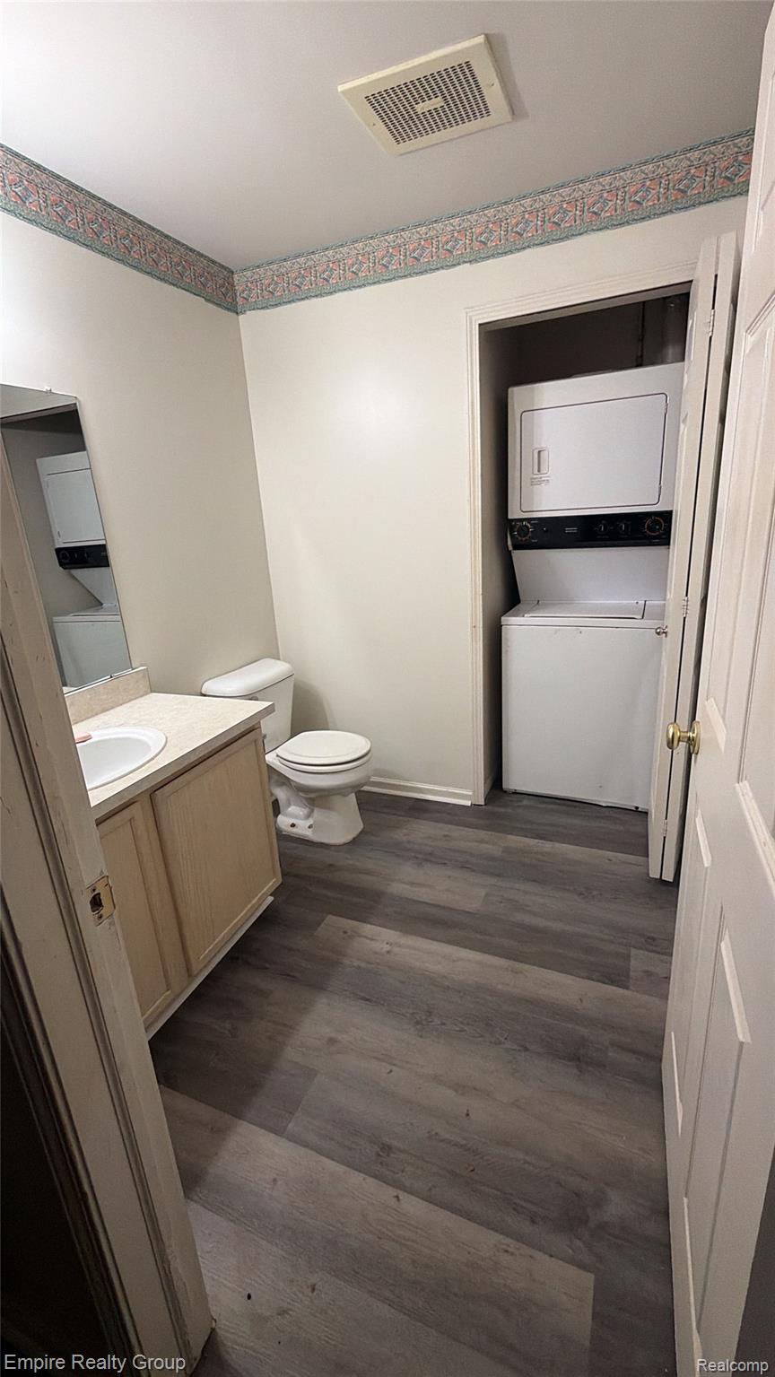 4316 Schaefer Road Dearborn, MI 48126 - Photo 1 of 6 Contemporary wood-finish flooring, single vanity with integrated sink, toilet, and stacked washer and dryer