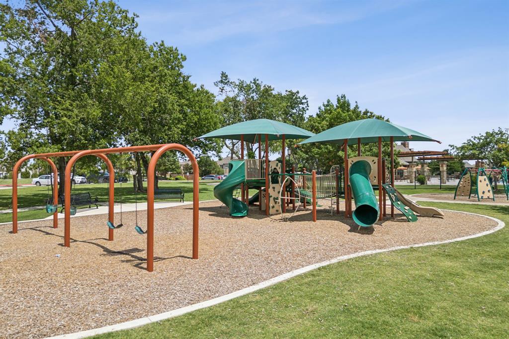1014 Dunhill Lane Forney, TX 75126 - Photo 33 of 38 Community playground featuring multiple play structures, a swing set, and green slides