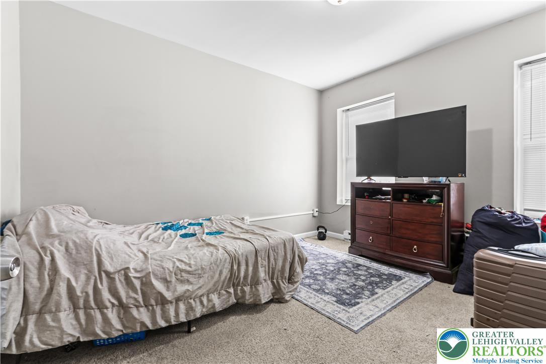 12 South Front Street Coplay, PA 18037 - Photo 29 of 41 This cozy bedroom features light walls, inviting carpet, and ample natural light, creating a comfortable living space.