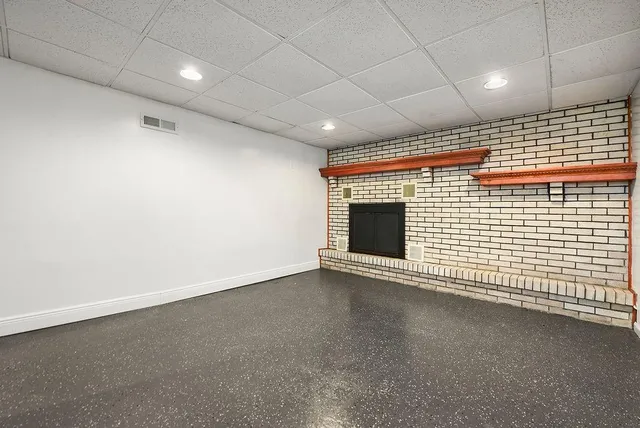 a view of an empty room with a fireplace