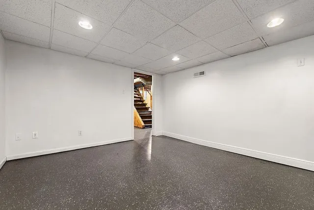 an empty room with a empty space and windows