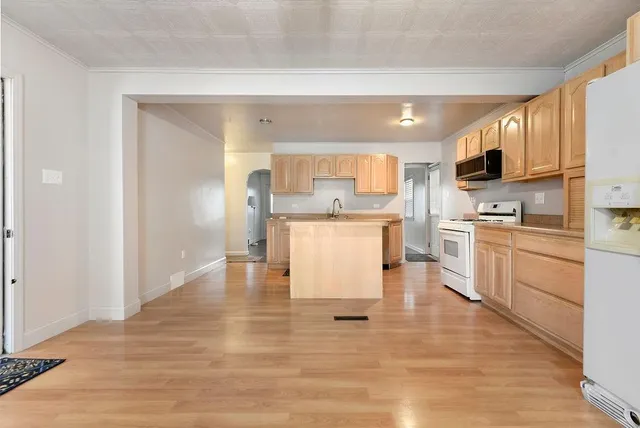 a kitchen with a refrigerator and a stove top oven