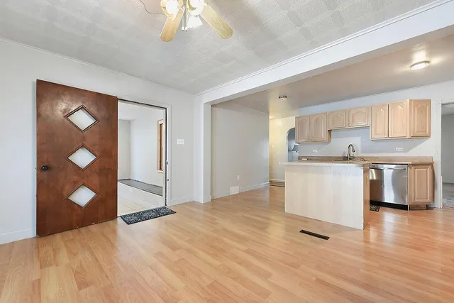 a kitchen with stainless steel appliances a refrigerator sink and cabinets