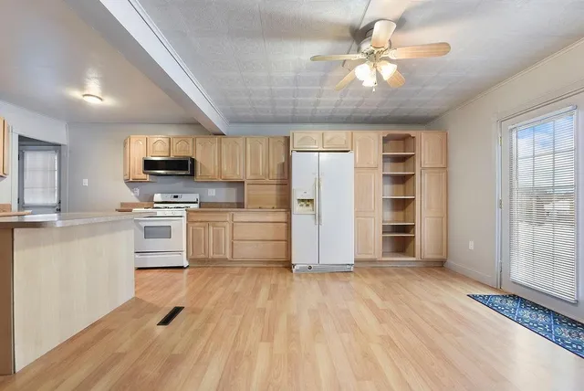 a kitchen with stove cabinets and refrigerator