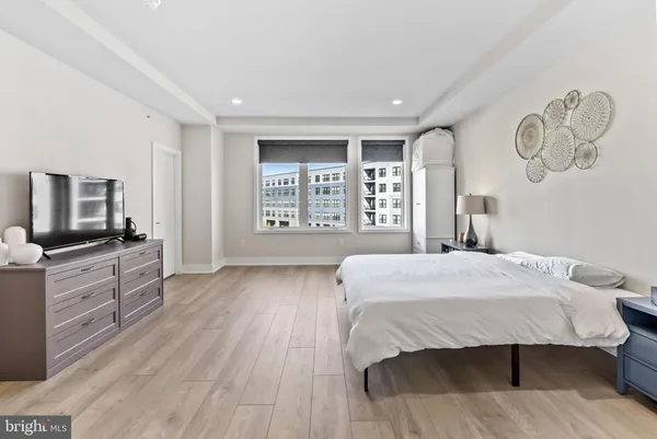 a large kitchen with cabinets wooden floor and stainless steel appliances