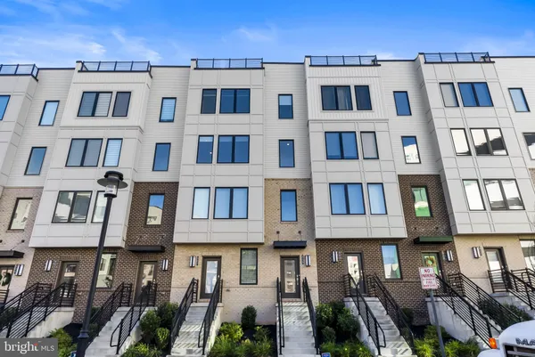 a front view of a residential apartment building with a yard