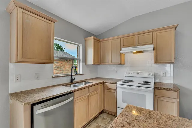 a kitchen with a stove and a sink