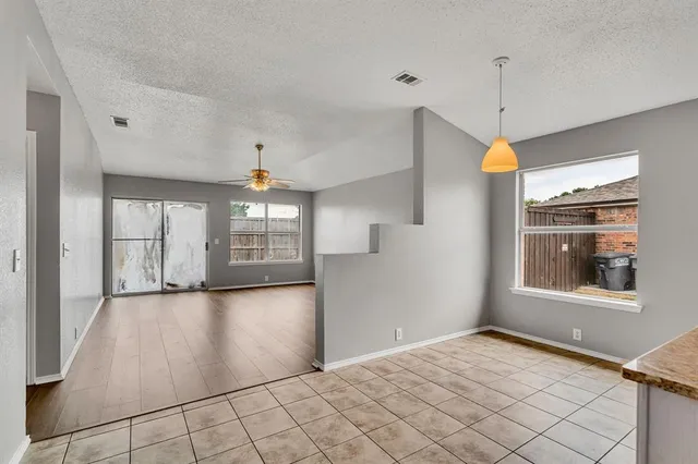 a kitchen with cabinets appliances a sink and a window