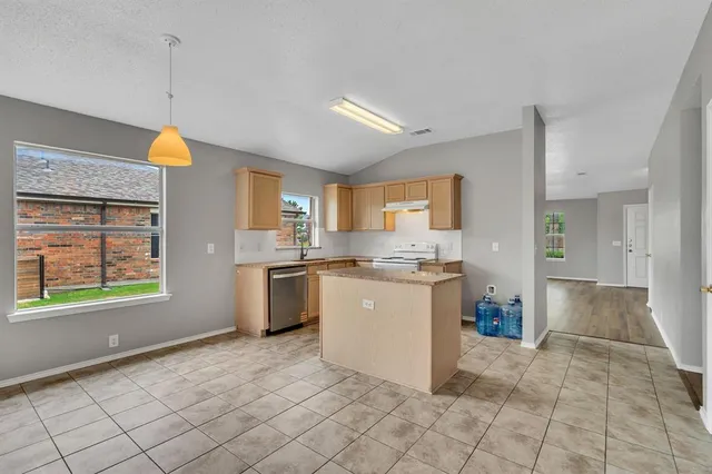 a large kitchen with cabinets and stainless steel appliances