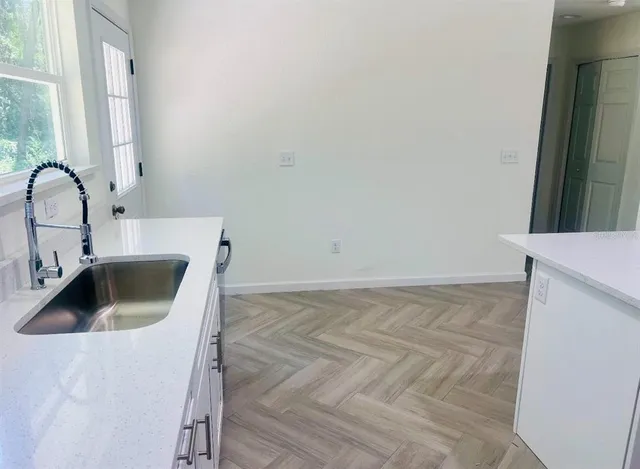 a kitchen with a sink and cabinets