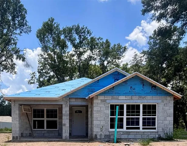 a view of a house with a tree in the background